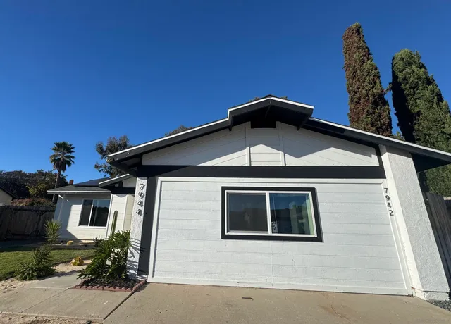 a front view of a house with yard
