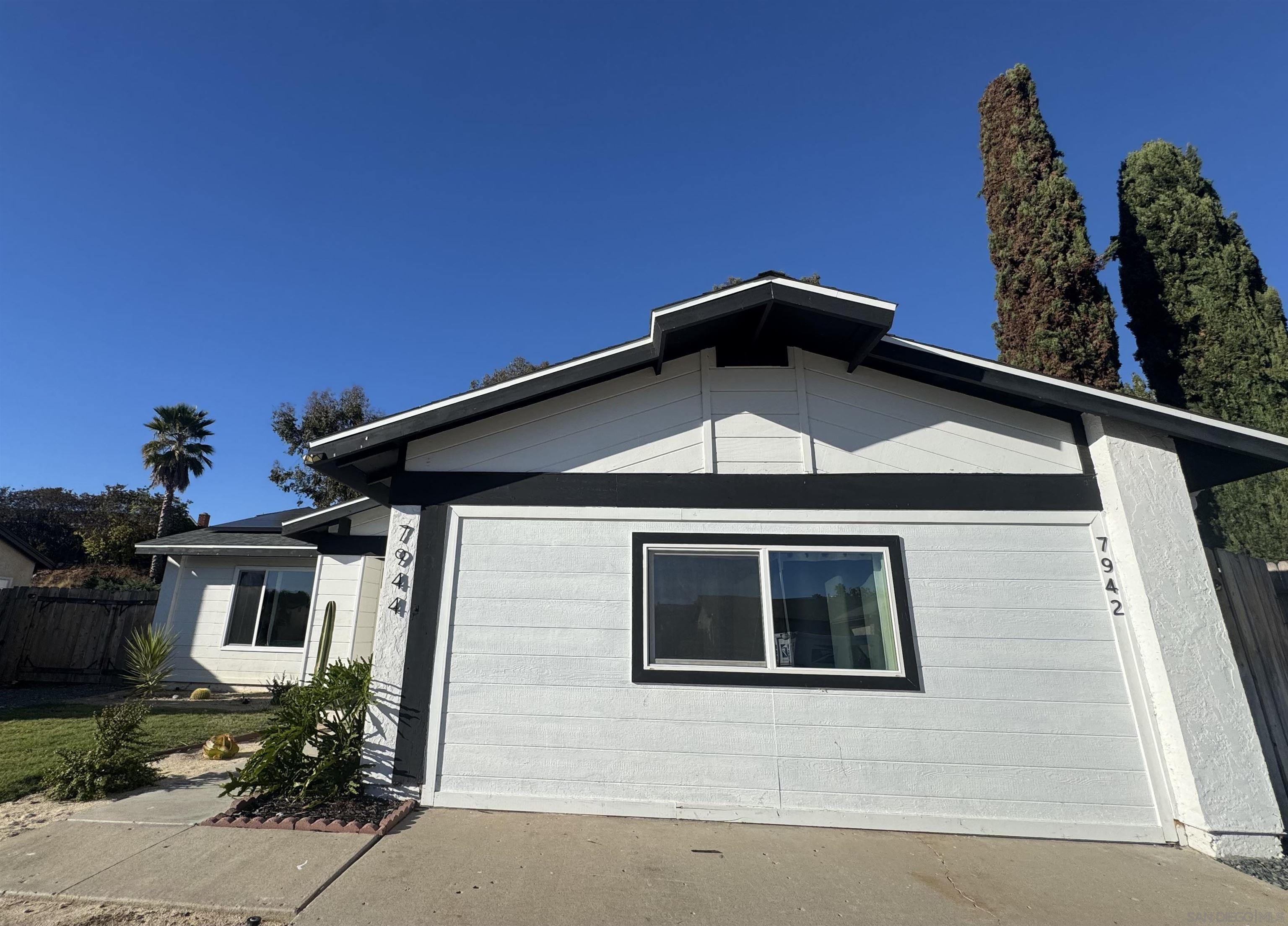 7942 Calico Street San Diego, CA 92126 - Photo 3 of 39 a front view of a house with yard