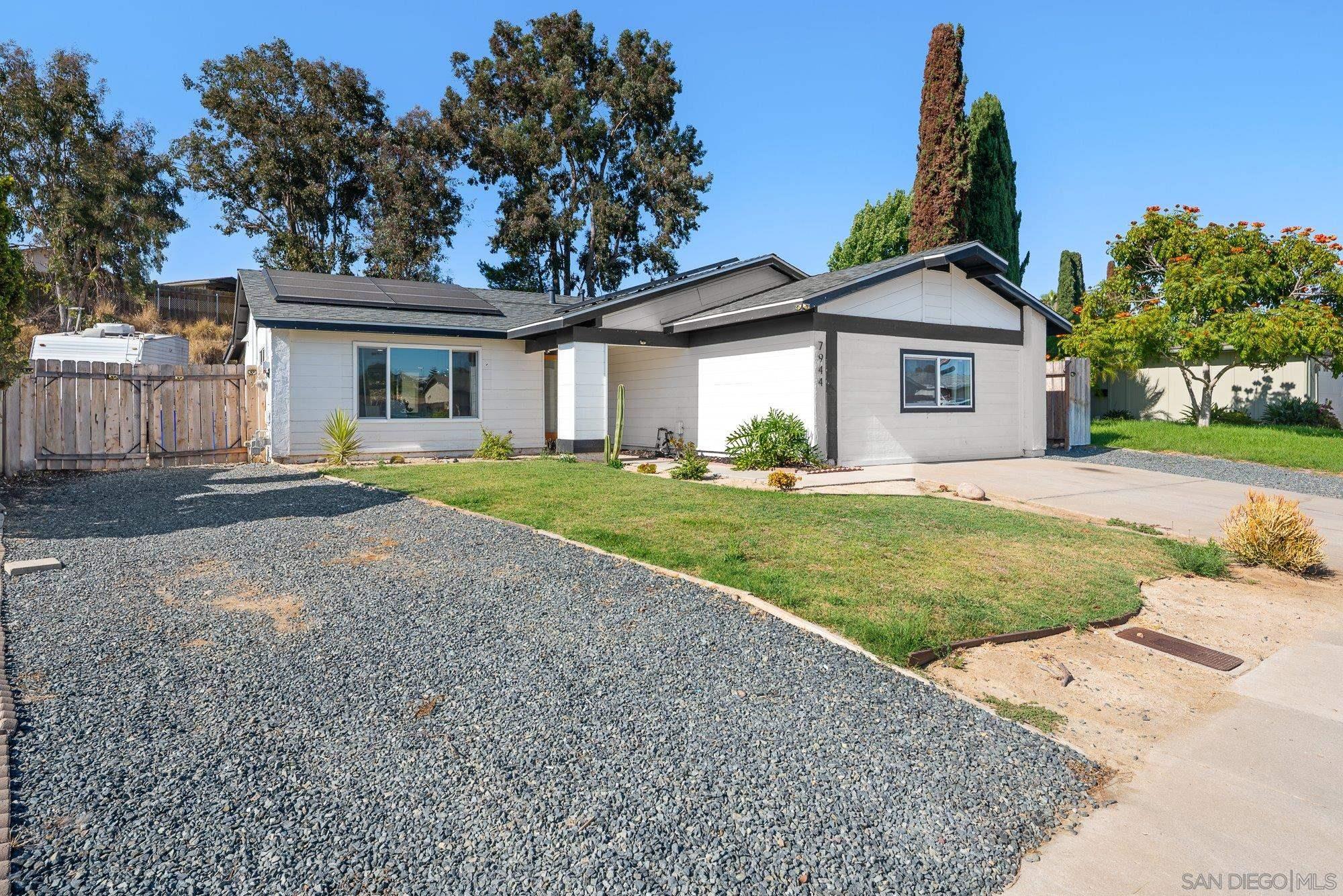 7942 Calico Street San Diego, CA 92126 - Photo 6 of 39 a front view of a house with a yard and garage