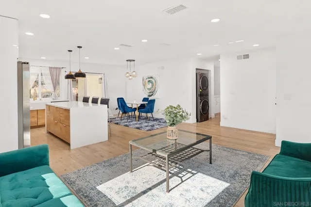 a living room with furniture and kitchen view
