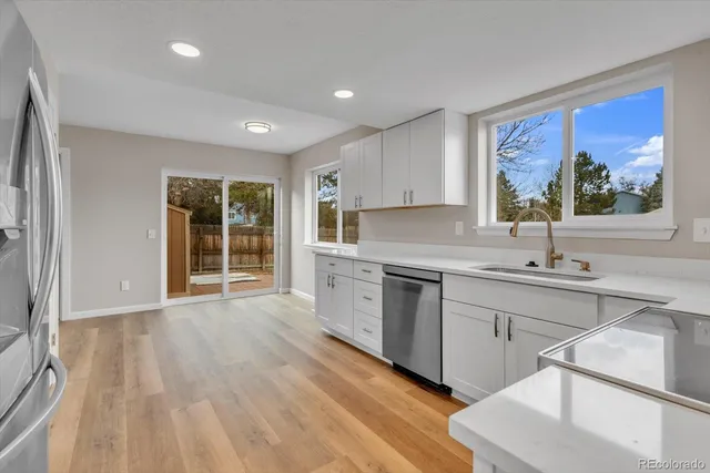 a kitchen with stainless steel appliances a stove microwave and sink