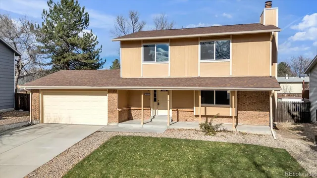 a front view of a house with yard patio and outdoor seating
