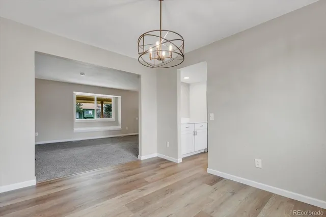 a view of a kitchen with a sink and a refrigerator