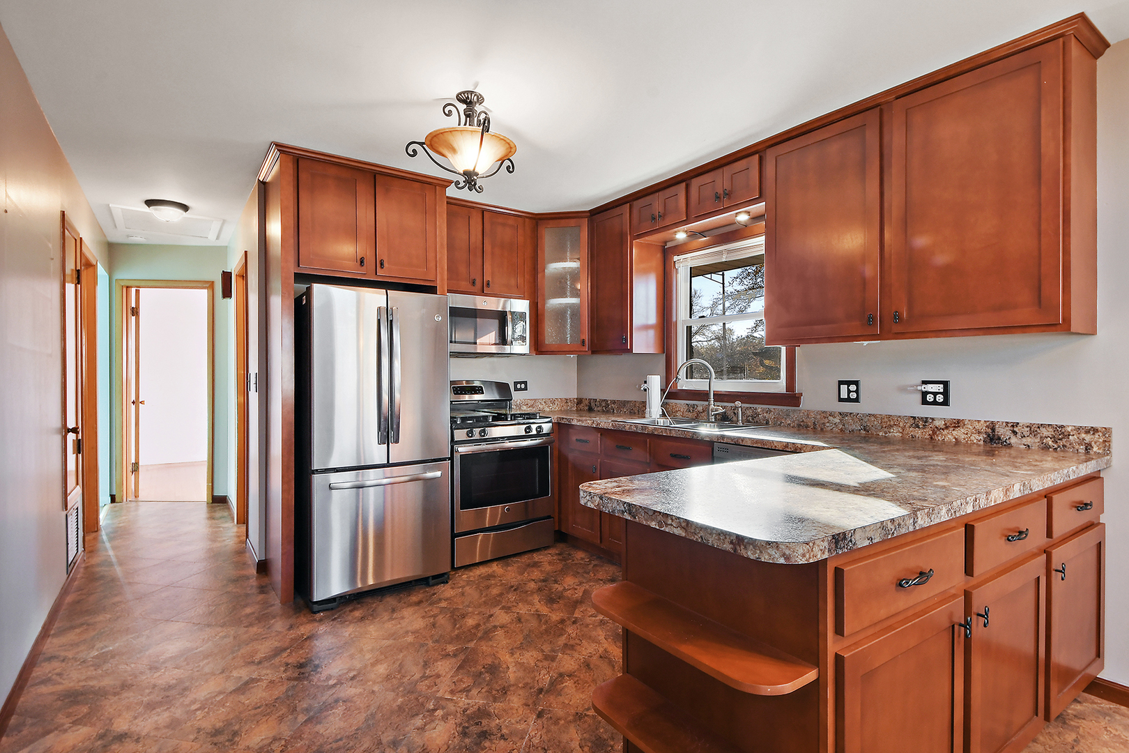 10536 Oak Avenue Chicago Ridge, IL 60415 - Photo 10 of 26 a kitchen with stainless steel appliances granite countertop a refrigerator a sink and a stove