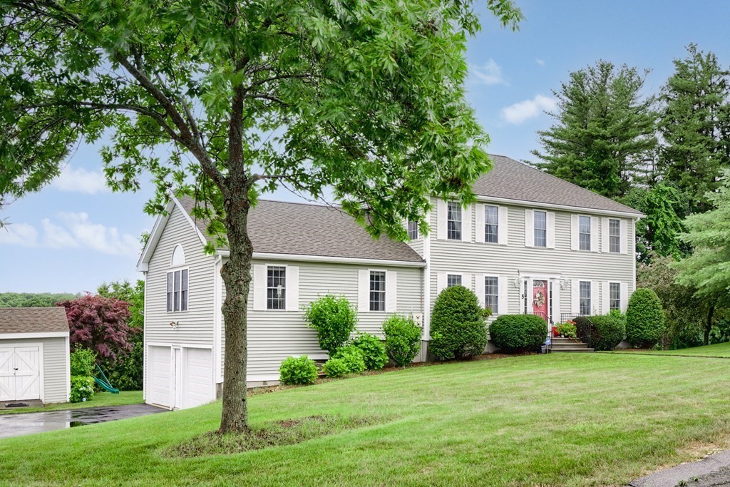 5 Jonathan Circle Rutland, MA 01543 - Photo 2 of 31 a front view of a house with a yard and garage