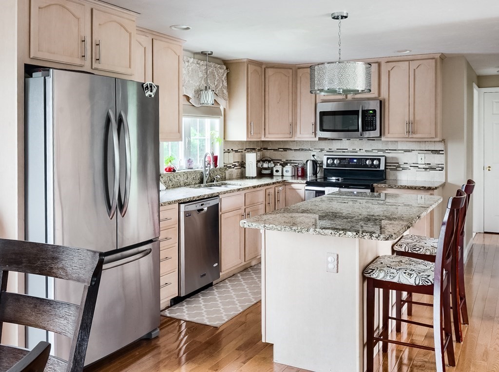 5 Jonathan Circle Rutland, MA 01543 - Photo 3 of 31 a kitchen with stainless steel appliances granite countertop a refrigerator stove microwave and sink