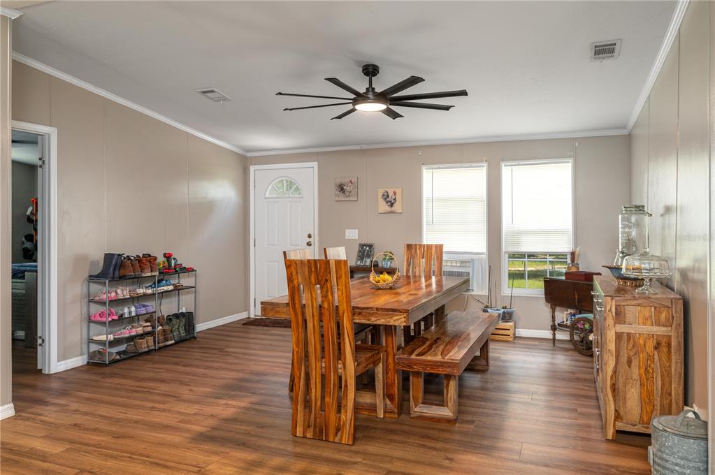 15079 Brahma Road Polk City, FL 33868 - Photo 4 of 40 a view of a dining room with furniture window and wooden floor