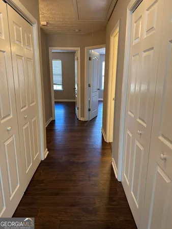 a view of a hallway with wooden floor