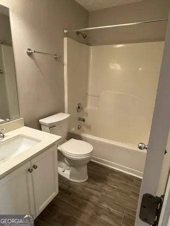 a bathroom with a toilet a sink and a shower