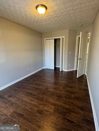 an empty room with wooden floor and entrance