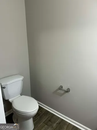 a white toilet sitting next to a shower