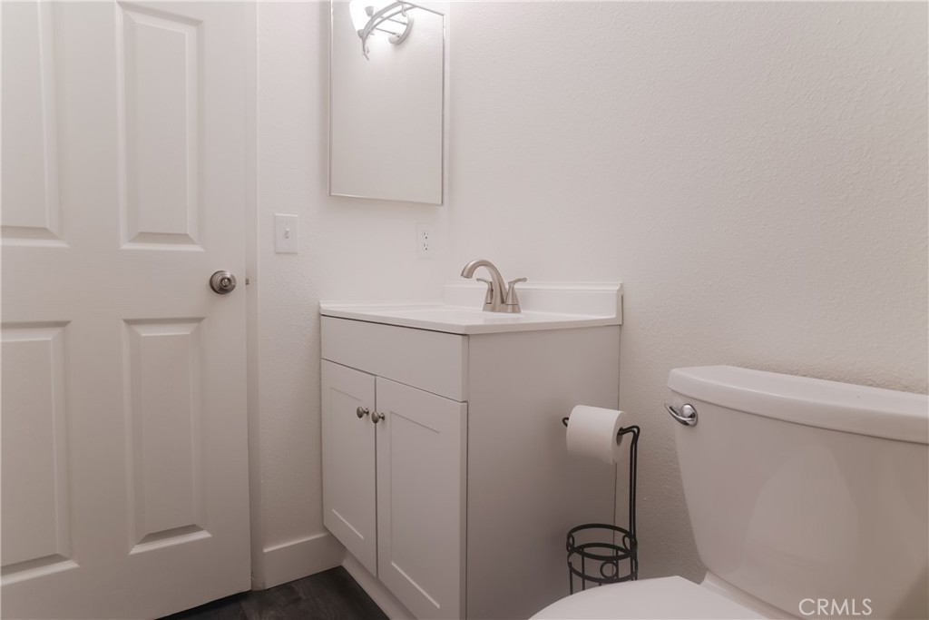 3880 West Jacinto View Road, Unit A Banning, CA 92220 - Photo 13 of 21 a bathroom with a sink a toilet and a mirror