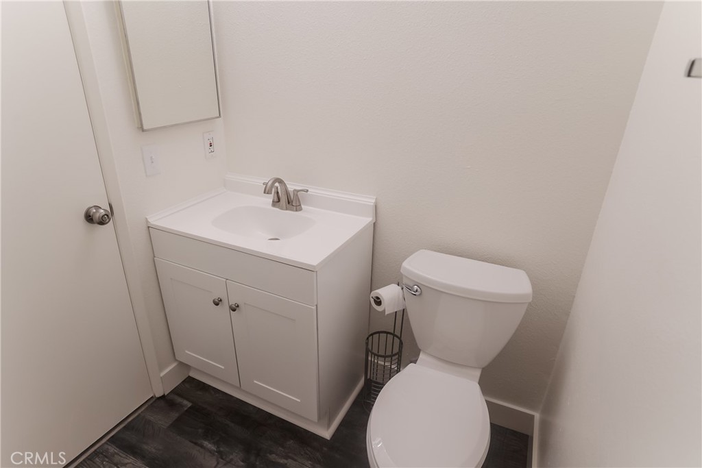 3880 West Jacinto View Road, Unit A Banning, CA 92220 - Photo 17 of 21 a bathroom with a toilet sink and mirror