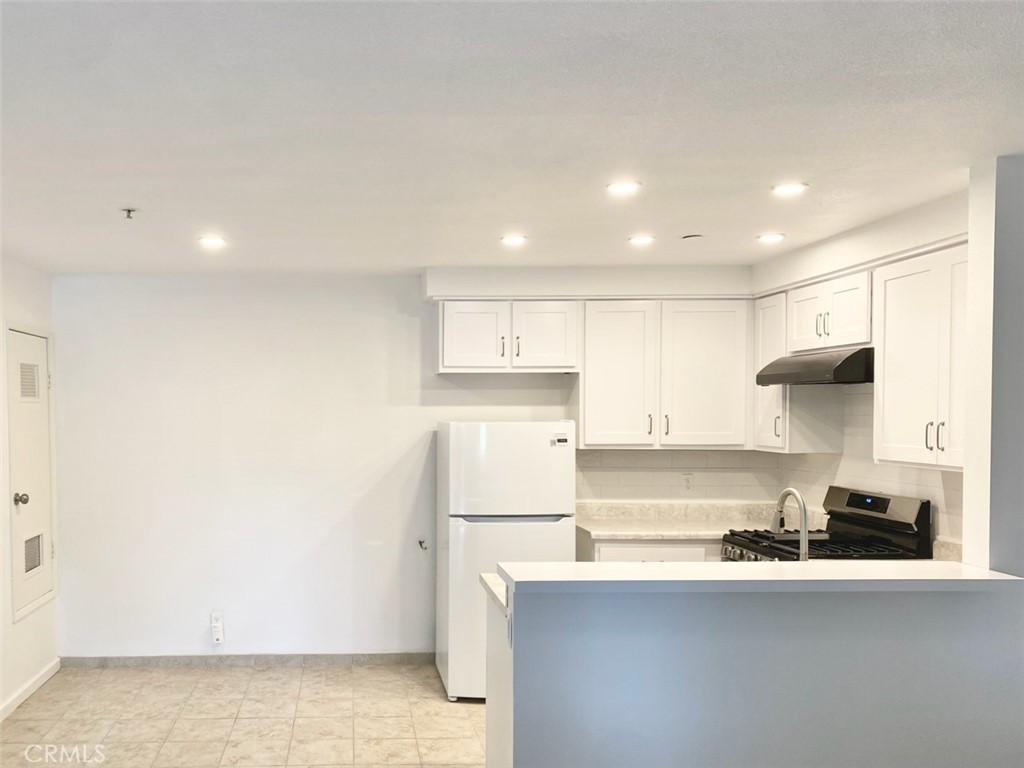 3880 West Jacinto View Road, Unit A Banning, CA 92220 - Photo 6 of 21 a kitchen with stainless steel appliances a sink stove and cabinets