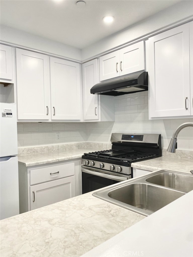 3880 West Jacinto View Road, Unit A Banning, CA 92220 - Photo 7 of 21 a kitchen with stainless steel appliances granite countertop a sink and a stove
