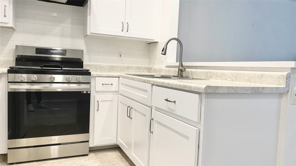 3880 West Jacinto View Road, Unit A Banning, CA 92220 - Photo 8 of 21 a kitchen with granite countertop white cabinets and white appliances