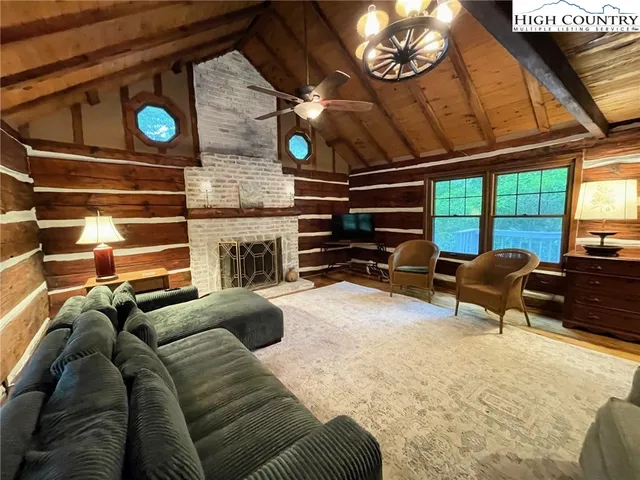 a view of a livingroom with furniture and a window