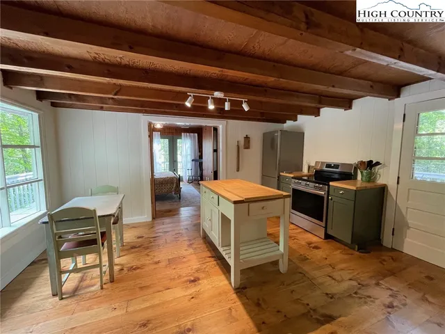 a kitchen with stainless steel appliances granite countertop a stove and a refrigerator