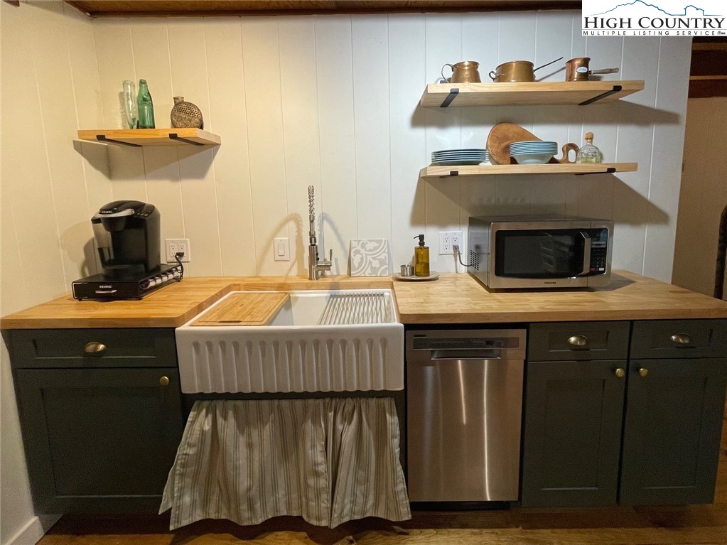 217 Holiday Hills Drive Boone, NC 28607 - Photo 22 of 47 a kitchen with a sink a stove and cabinets
