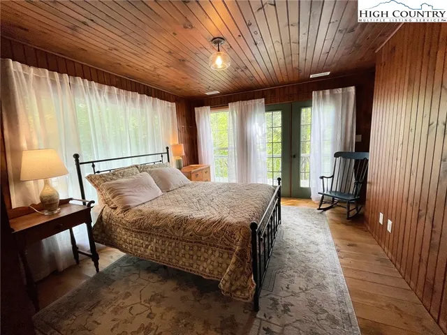 a bedroom with a large bed and a dresser
