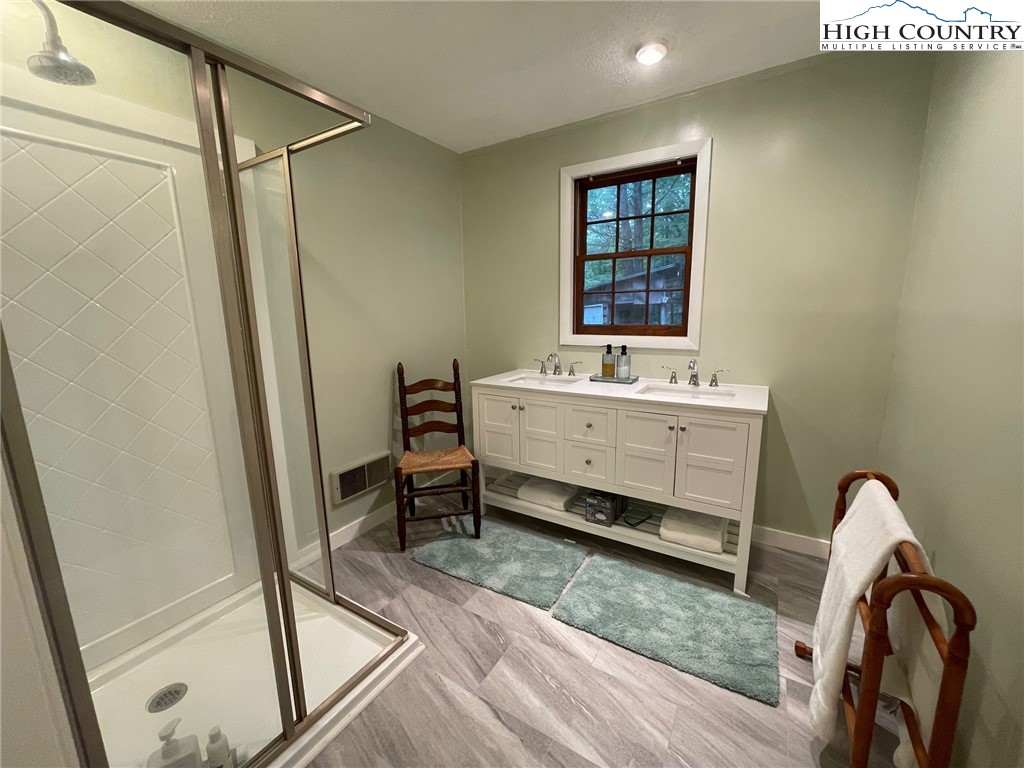 217 Holiday Hills Drive Boone, NC 28607 - Photo 30 of 47 a view of a bathroom with tub and sink