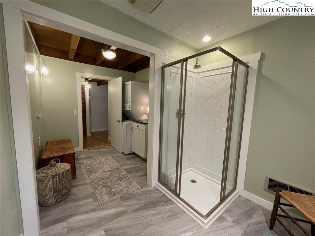 217 Holiday Hills Drive Boone, NC 28607 - Photo 31 of 47 a view of a hallway with wooden floor and a bathroom