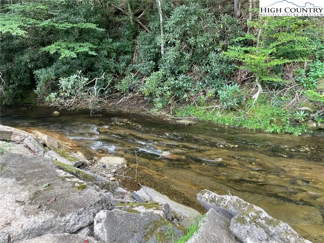 a backyard of a house with a yard and outdoor seating