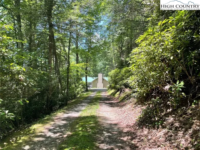 an aerial view of a house with a yard and outdoor seating