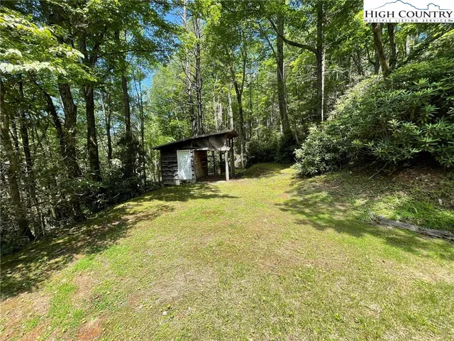 a swimming pool with outdoor seating and yard