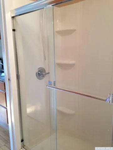 a bathroom with a glass shower door