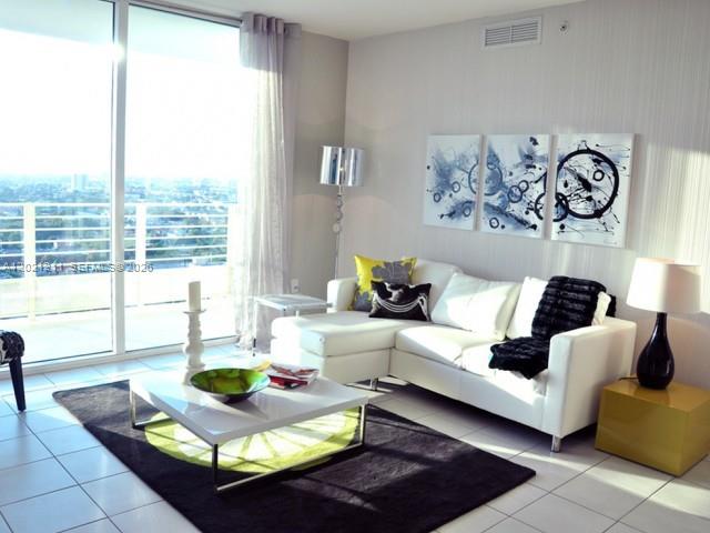 110 Southwest 12th Street, Unit 708 Miami, FL 33130 - Photo 3 of 10 a living room with furniture and a large window
