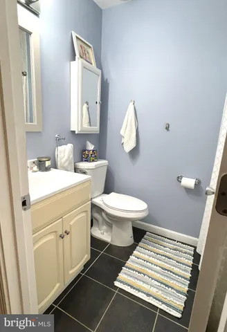 a bathroom with a sink toilet and mirror