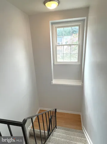 a view of entryway with wooden floor and window