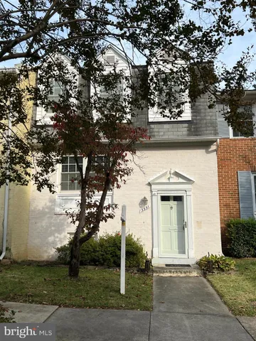 front view of a house with a tree