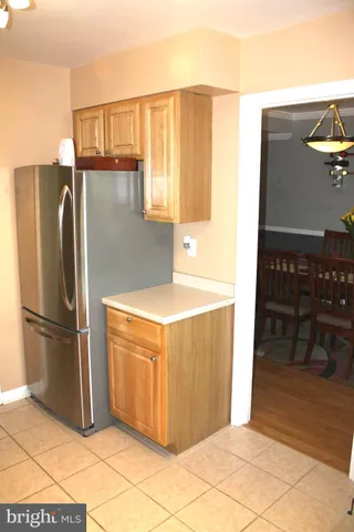a kitchen with stainless steel appliances granite countertop a refrigerator and a stove