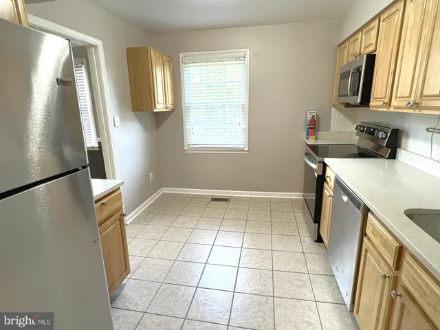a view of a kitchen with a sink a microwave and refrigerator