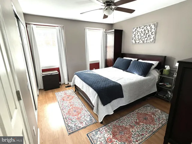 a bedroom with a bed lamp and a dresser