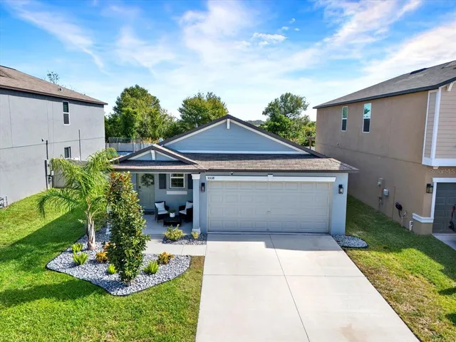 a aerial view of a house next to a yard