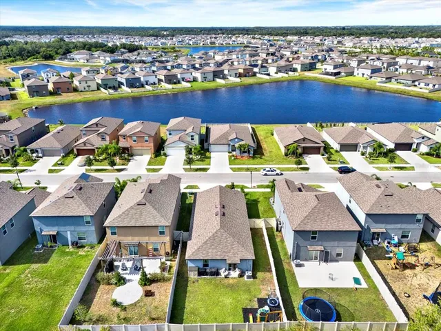 an aerial view of a house with swimming pool and ocean view