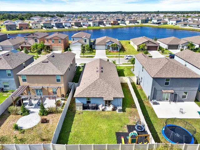an aerial view of a house with a swimming pool yard and outdoor seating