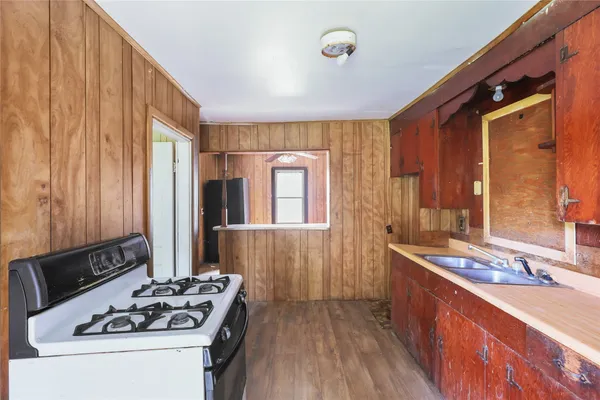 a kitchen that has a sink and a stove