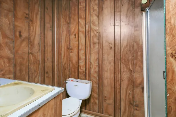 a bathroom with a toilet and shower