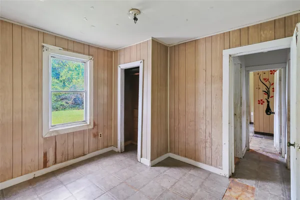 an empty room with windows and closet