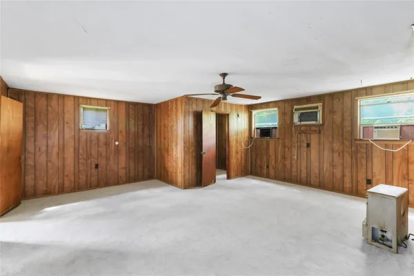 a view of a livingroom with a chandelier fan