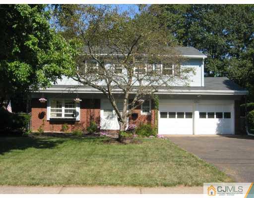 3 Kyle Road Somerset, NJ 08873 - Photo 1 of 10 a view of a white house with a yard table and chairs