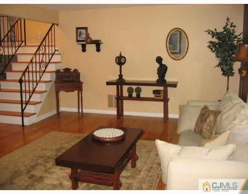 3 Kyle Road Somerset, NJ 08873 - Photo 5 of 10 a living room with furniture a rug and a wall painting