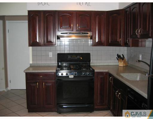 3 Kyle Road Somerset, NJ 08873 - Photo 6 of 10 a kitchen with granite countertop a stove and a microwave