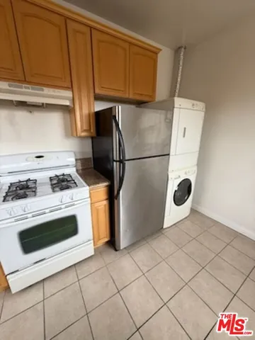 a kitchen with a stove top oven and cabinets