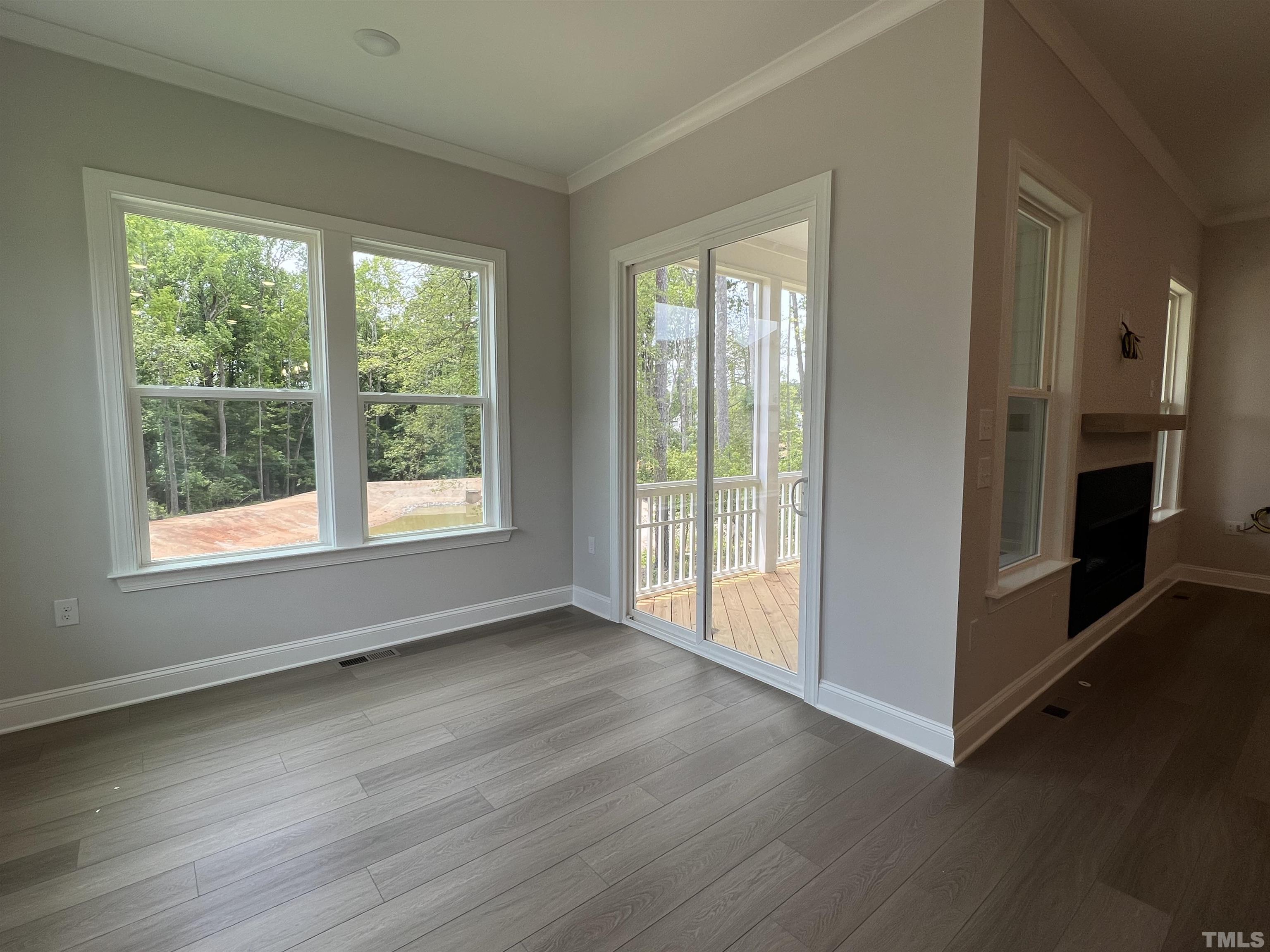7629 Hasentree Way, Unit 519 Wake Forest, NC 27587 - Photo 25 of 76 a view of an empty room with wooden floor and a window