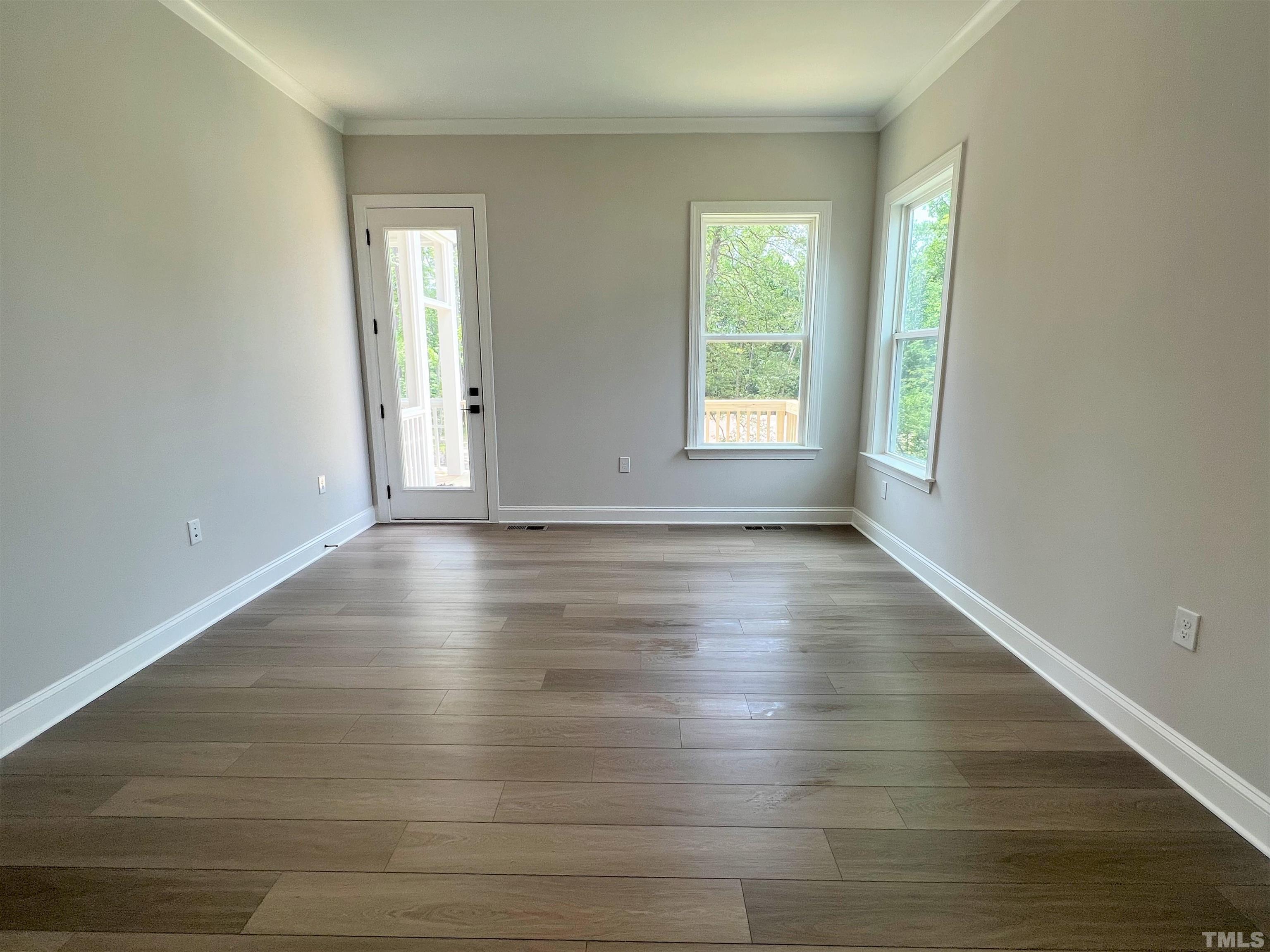 7629 Hasentree Way, Unit 519 Wake Forest, NC 27587 - Photo 30 of 76 a view of an empty room with wooden floor and window